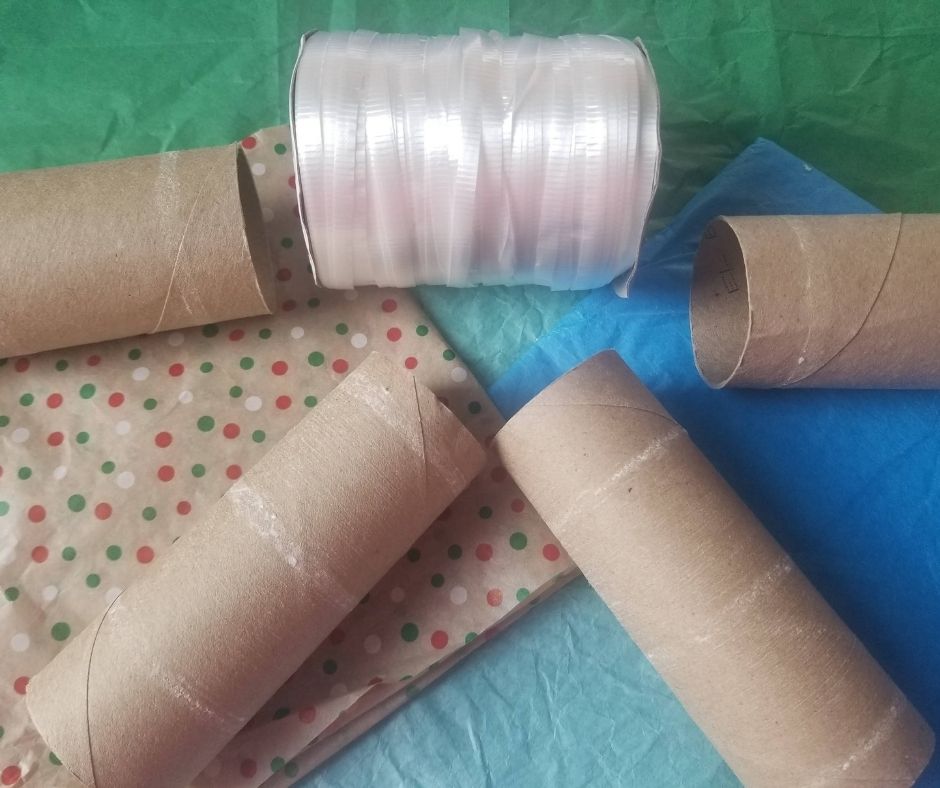 Supplies to make your Confetti Party Poppers at home. All you need is toilet paper rolls, tissue paper, and ribbon..