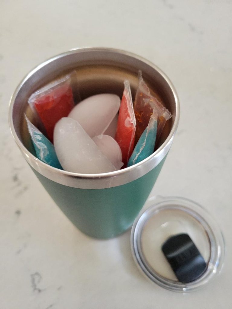 A simple beach hack to keep your kids ice pops frozen by adding it to a Yeti cup with ice cubes.