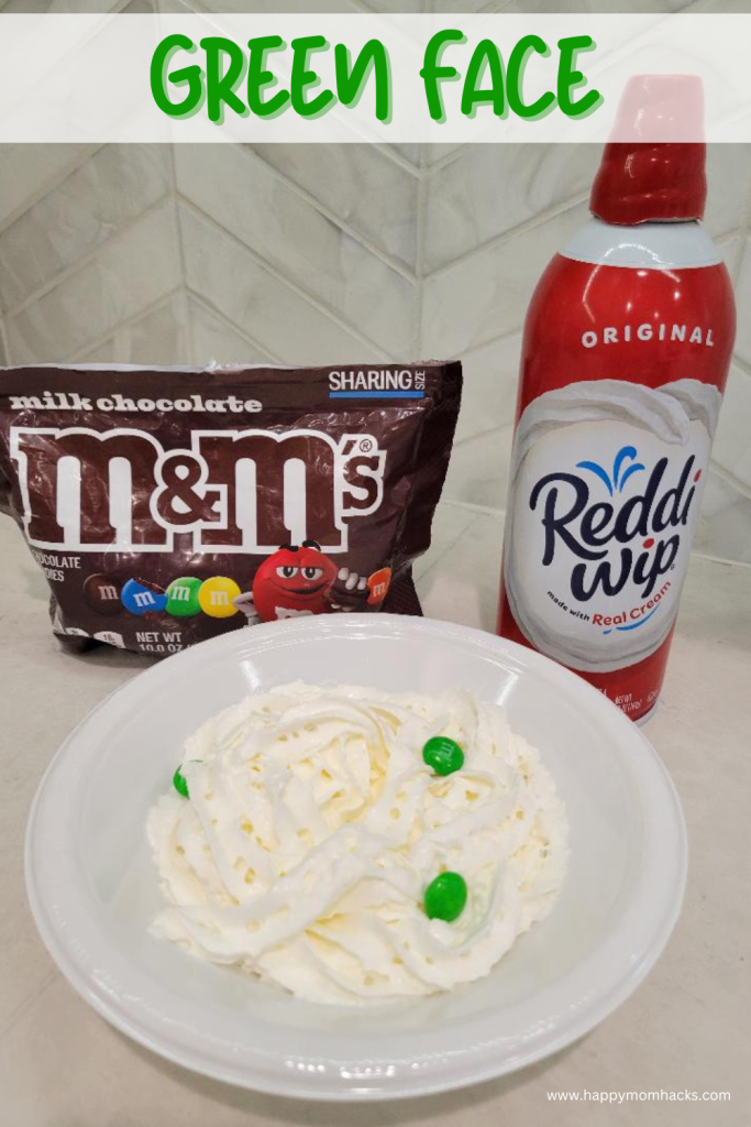 Hilarious & messy St. Patrick's Day Minute to Win It game Green Face. Players have a 60 sescond challenge to use their face to find all the green M&Ms in a whipped cream filled bowl. Fun game for St. Patrick's Day parties with kids, teens and adults.