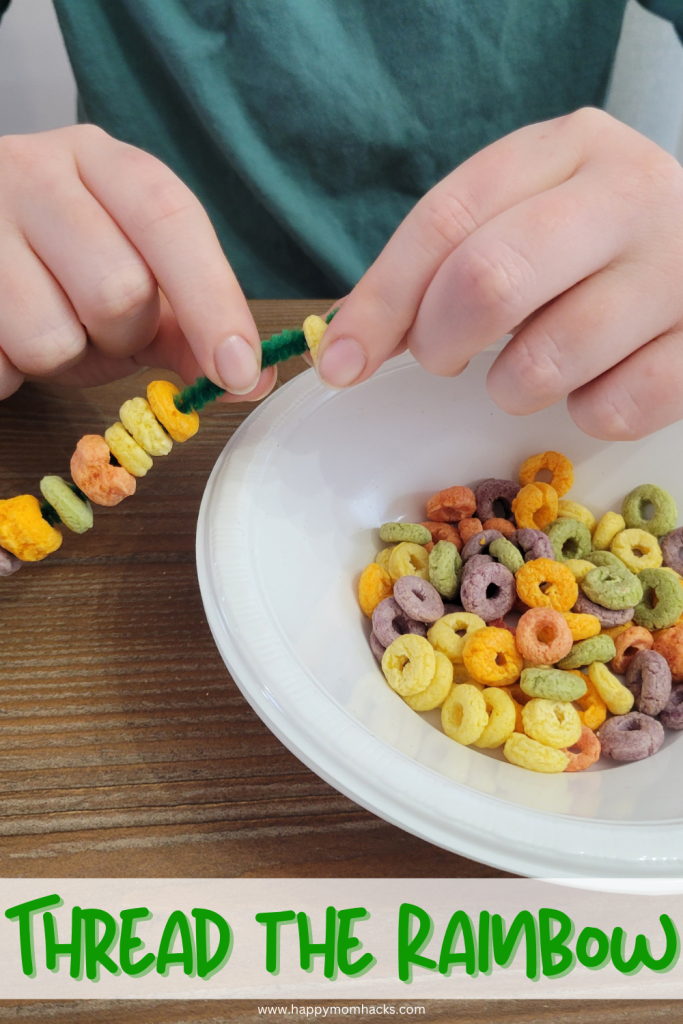 Easy St. Patrick's Day Minute to Win it game called Thread the Rainbow. Players have 60 seconds to string Rainbow Fruit Loops to a pipe cleaner.