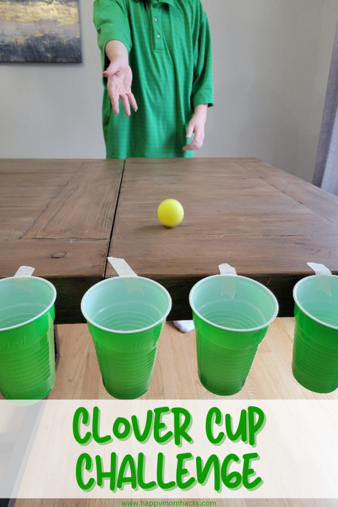 Fun St. Patrick's Day party game for kids, teens and adults. Players have a 60 second challenge to roll as many gold ping pong balls as they can into the hanging green cups. A fun St. Patrick's Day Minute to Win It Game for all ages!