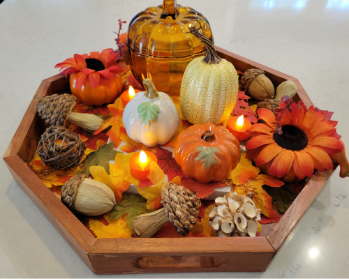 Create DIY fall decor with a wooden tray, pumpkins, fake leaves and mini LED candles. All cheap and cute fall decor items from Dollar Tree you can easily add to a wooden tray for your fall centerpiece.