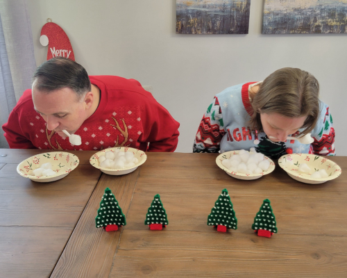 Fun Minute to Win It Christmas game called Snowball Pick Up. A funny christmas game moving cotton balls between bowls using a plastic spoon between your teeth. Try and finish the challenge before the 1 minute timer is up.