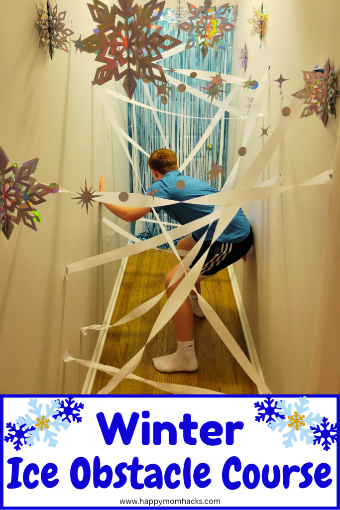 Create an easy DIY Hallway Ice obstacle course for kids. A fun frozen themed indoor laser maze created with streamers and snowflakes. Make ita winter game by timing the kids as they race through the indoor obastacle couse. A fun winter party game for birthdays and classroom parties.