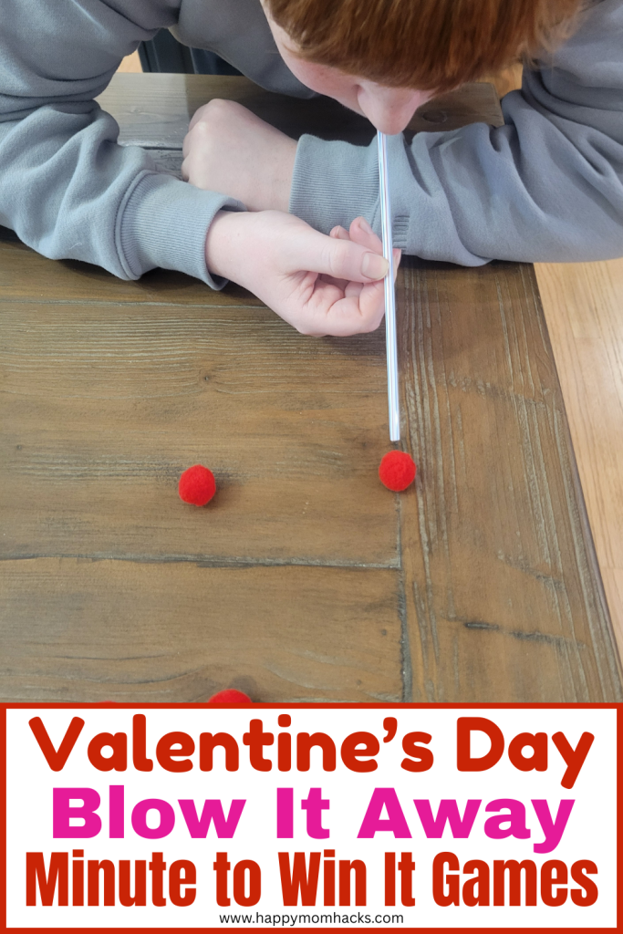 Fun Valentine's Day Game for groups playing Minute to Win It Blow it Away. Using a straw and pom poms players try and blow the pompoms across the table in this 60 second challenge.